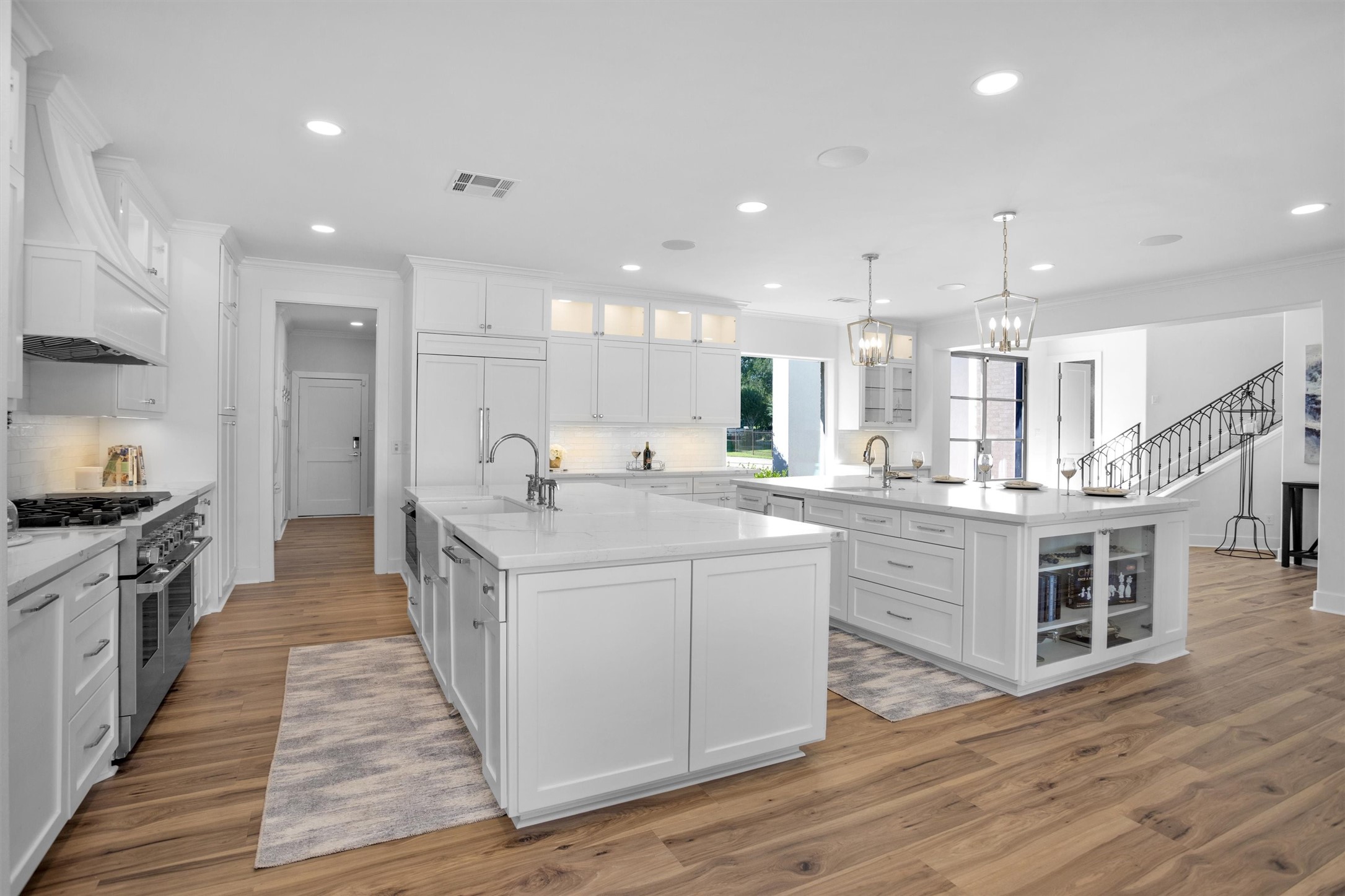 16059 Walden Road Conroe, TX 77356 - Photo 13 of 50 a large kitchen with kitchen island wooden floors and stainless steel appliances