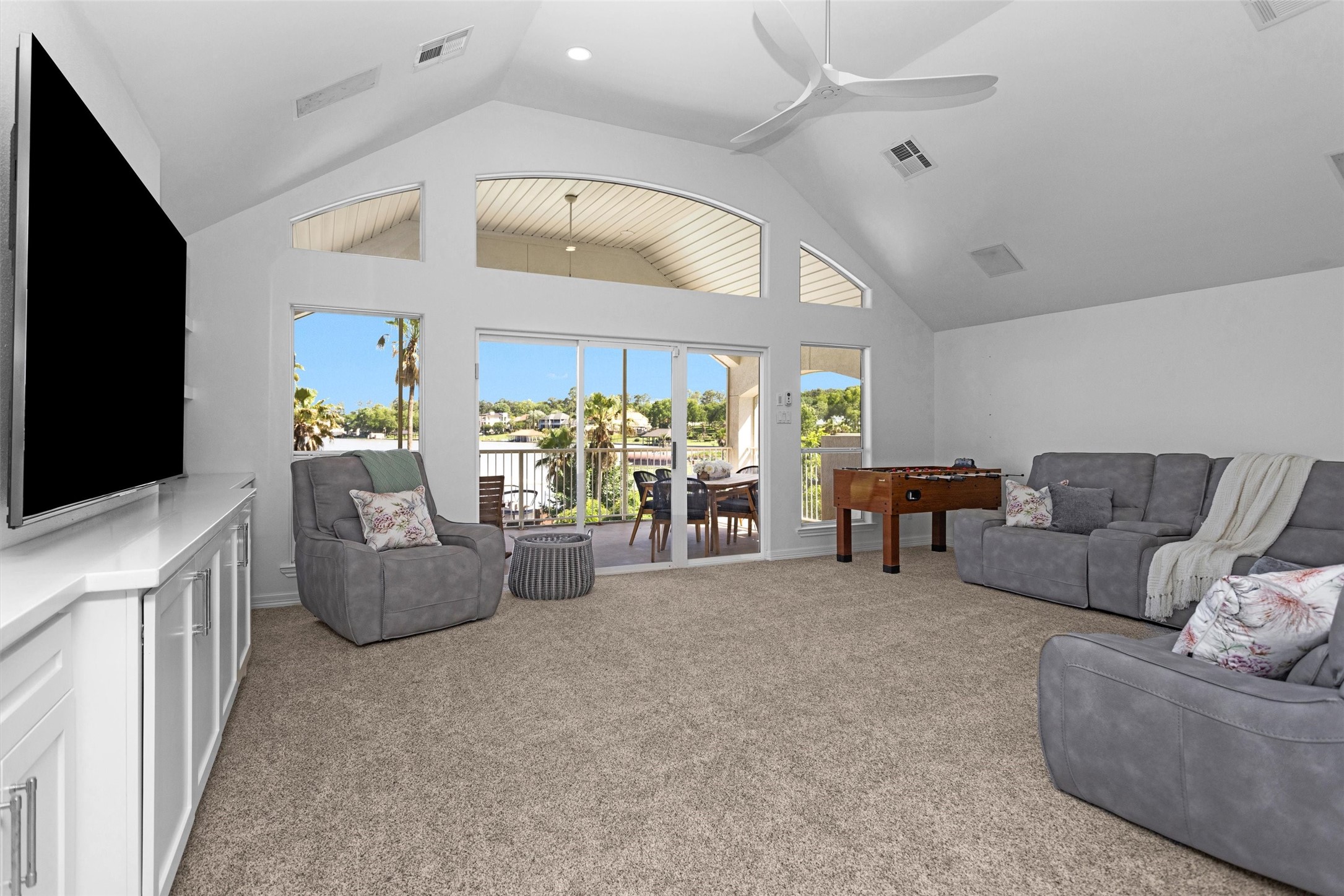 16059 Walden Road Conroe, TX 77356 - Photo 30 of 50 a living room with furniture and a flat screen tv