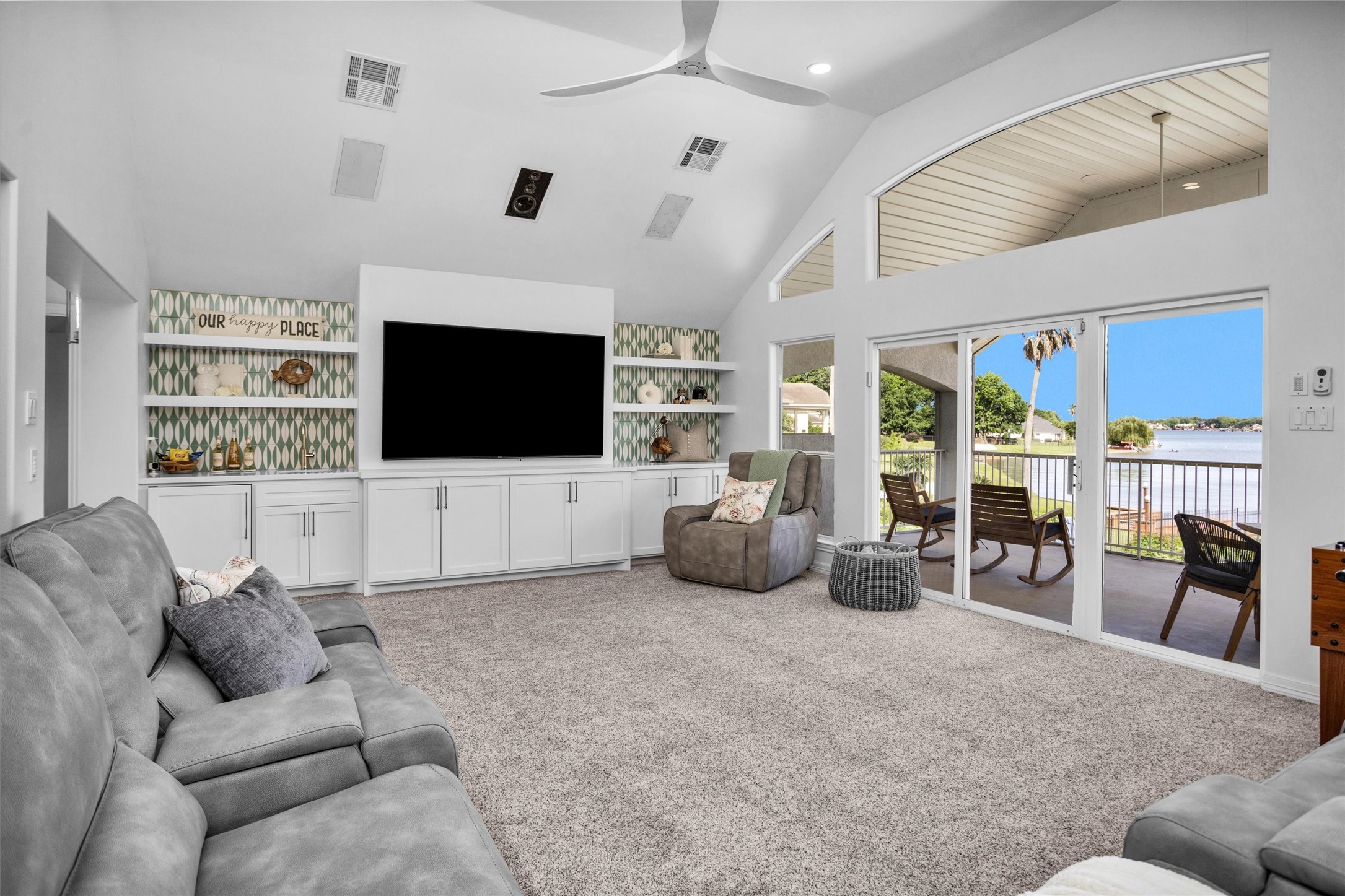 16059 Walden Road Conroe, TX 77356 - Photo 31 of 50 a living room with furniture a flat screen tv and kitchen view