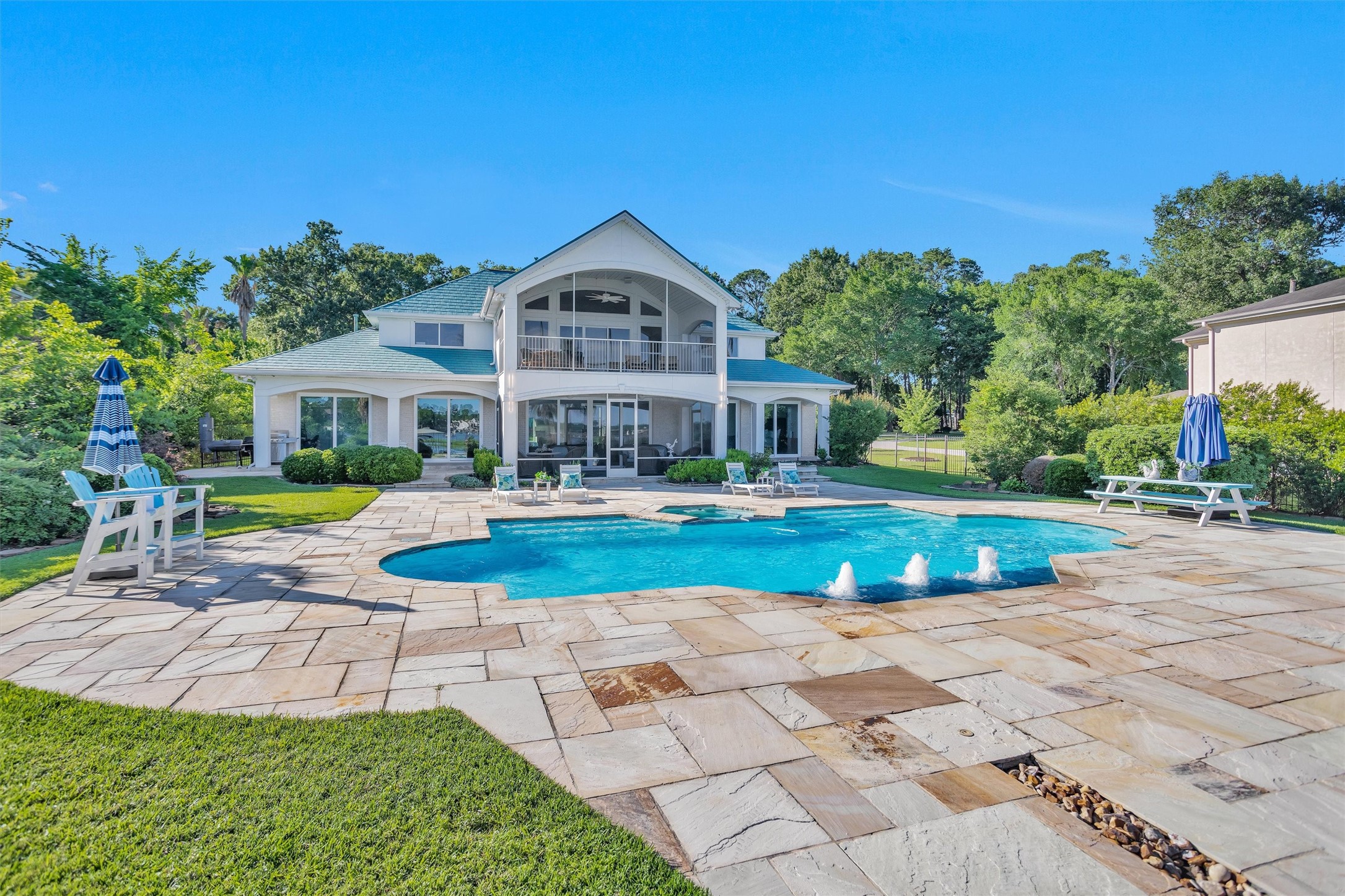 16059 Walden Road Conroe, TX 77356 - Photo 39 of 50 a view of pool with lawn chairs and plants