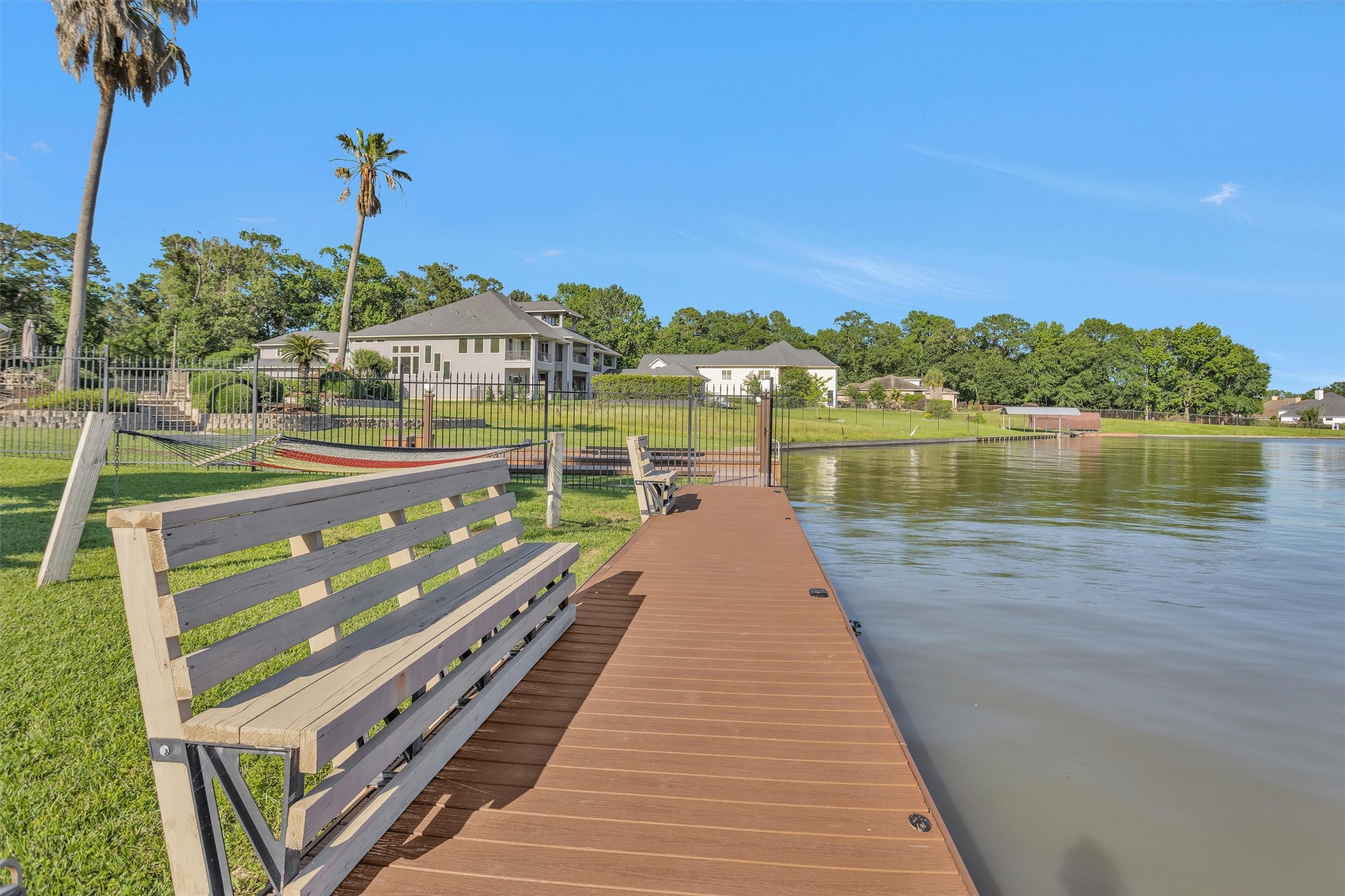 16059 Walden Road Conroe, TX 77356 - Photo 45 of 50 a view of a lake with a floor to ceiling window next to a yard