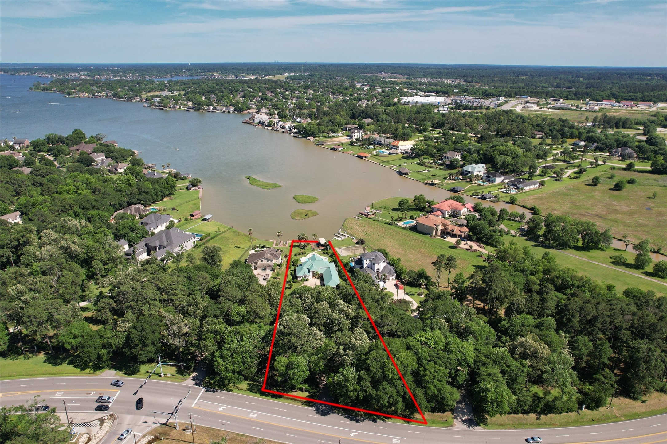 16059 Walden Road Conroe, TX 77356 - Photo 46 of 50 a view of a lake with houses