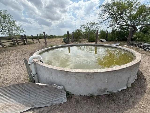 a view of a swimming pool with a yard