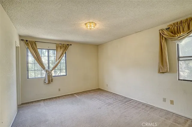 an empty room with windows and closet