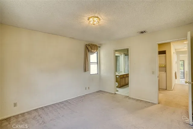 wooden floor in an empty room with a bathroom