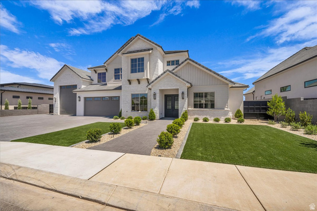 1620 Belayer Drive St. George, UT 84770 - Photo 3 of 51 White brick and stucco exterior featuring multiple gables and dark-framed windows