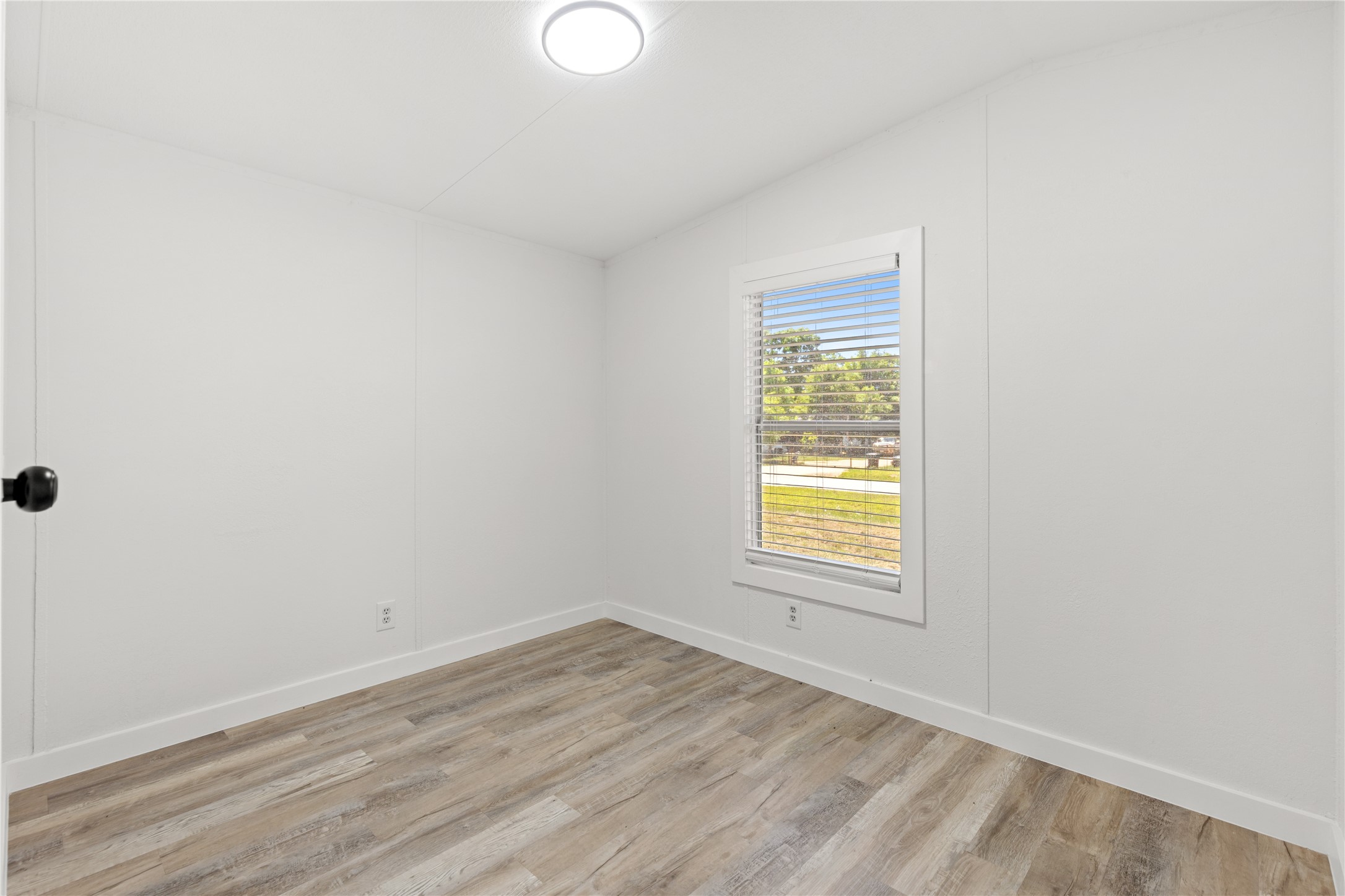 2134 County Road 5017 Cleveland, TX 77327 - Photo 11 of 25 an empty room with a window