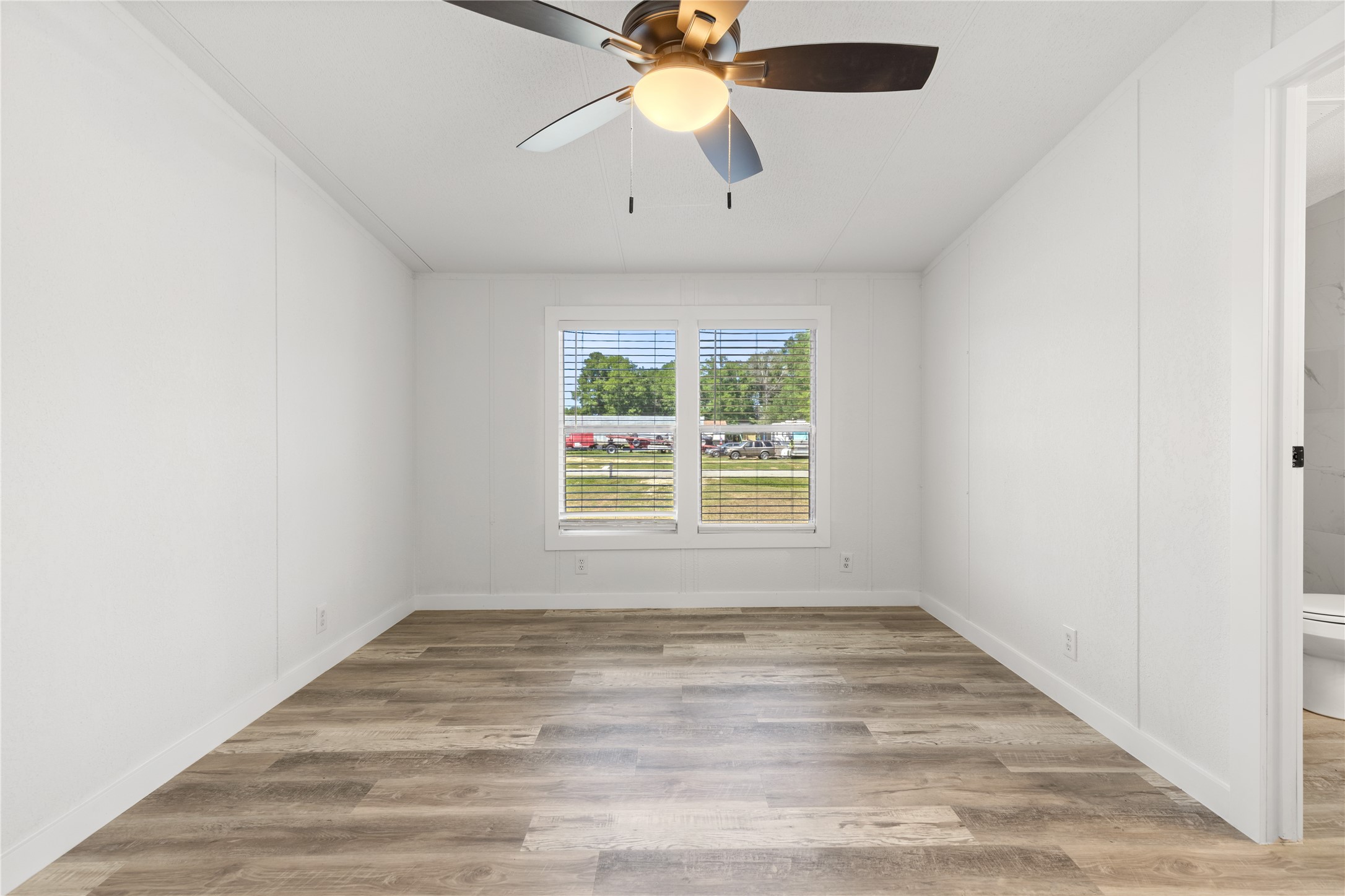 2134 County Road 5017 Cleveland, TX 77327 - Photo 16 of 25 an empty room with window and a chandelier fan