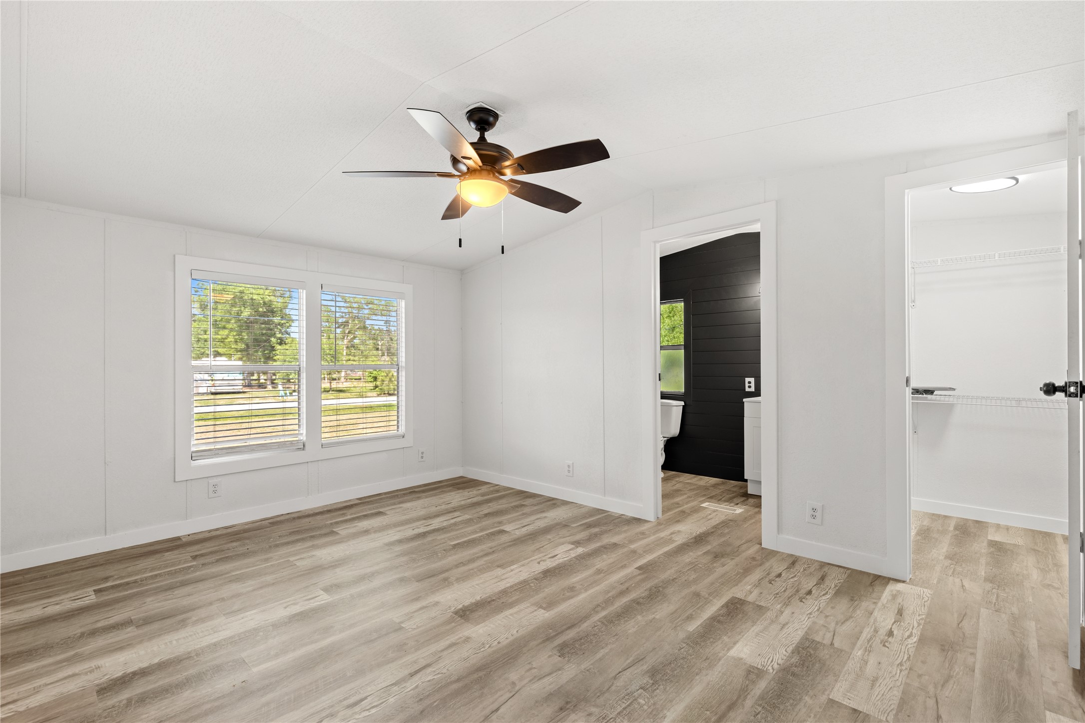 2134 County Road 5017 Cleveland, TX 77327 - Photo 17 of 25 wooden floor in an empty room with a window