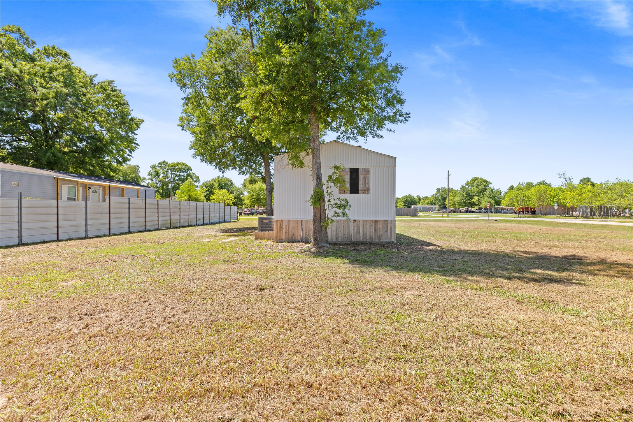 2134 County Road 5017 Cleveland, TX 77327 - Photo 22 of 25 a view of backyard space and tree