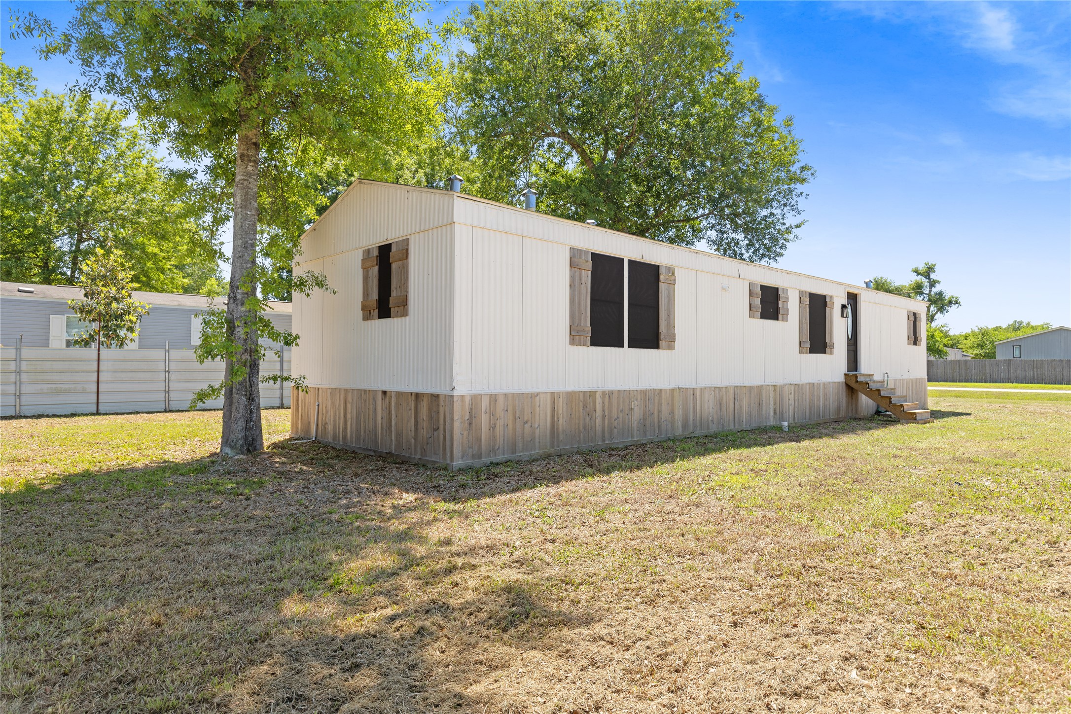 2134 County Road 5017 Cleveland, TX 77327 - Photo 23 of 25 a view of a backyard of the house