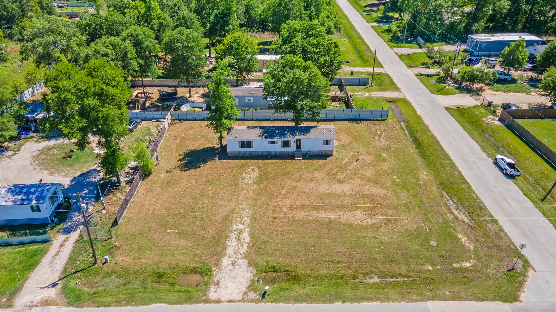 2134 County Road 5017 Cleveland, TX 77327 - Photo 24 of 25 a view of a swimming pool with a patio