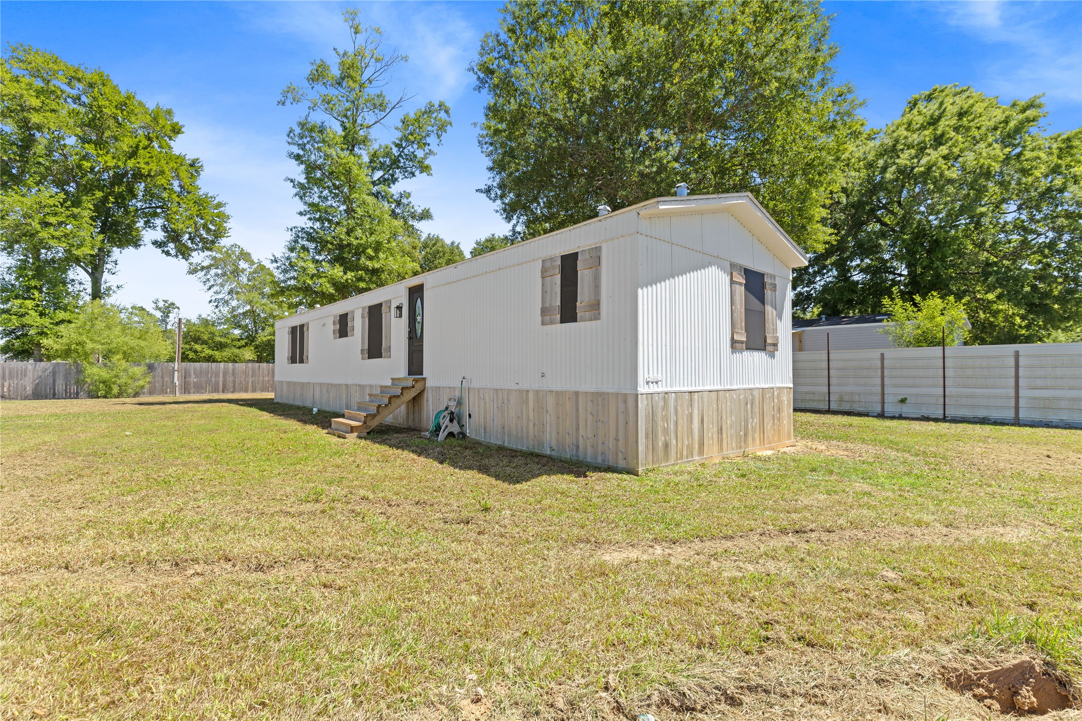 2134 County Road 5017 Cleveland, TX 77327 - Photo 3 of 25 a house view with a backyard space