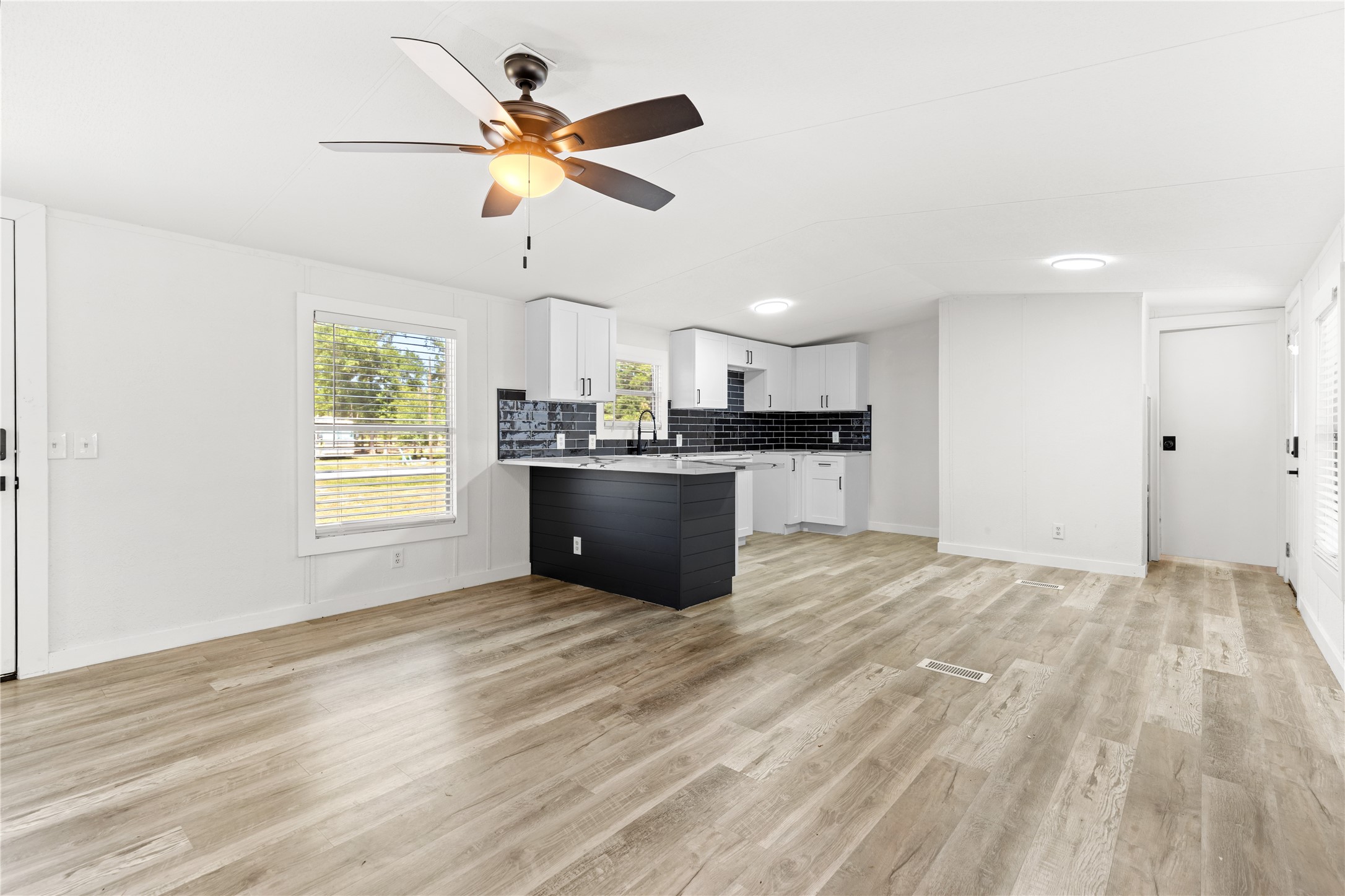 2134 County Road 5017 Cleveland, TX 77327 - Photo 5 of 25 a kitchen with stainless steel appliances kitchen island granite countertop a refrigerator and a sink