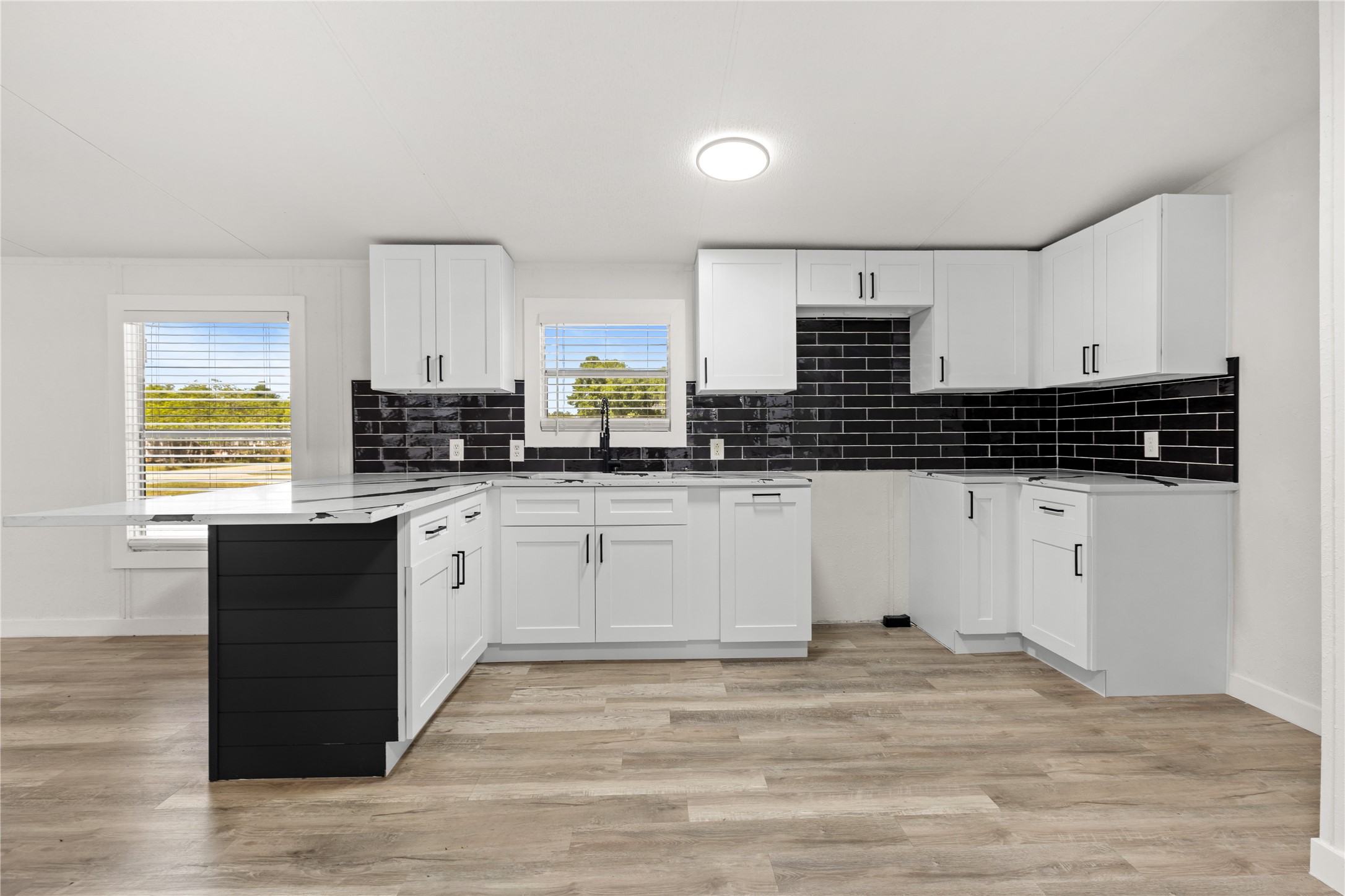 2134 County Road 5017 Cleveland, TX 77327 - Photo 6 of 25 a kitchen with stainless steel appliances granite countertop a stove a sink and white cabinets