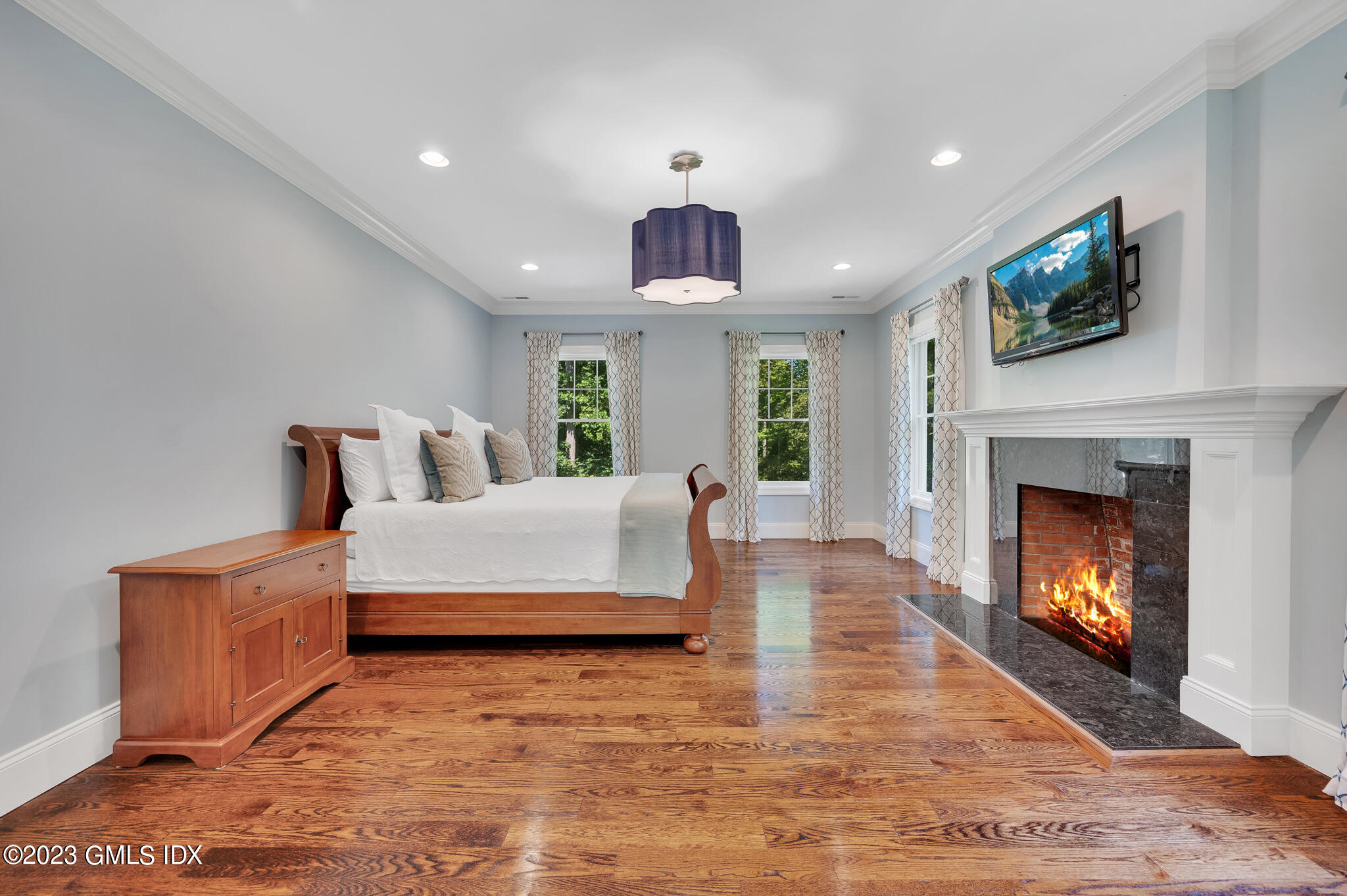 58 Perkins Road Greenwich, CT 06830 - Photo 18 of 30 a spacious bedroom with a bed and a fireplace