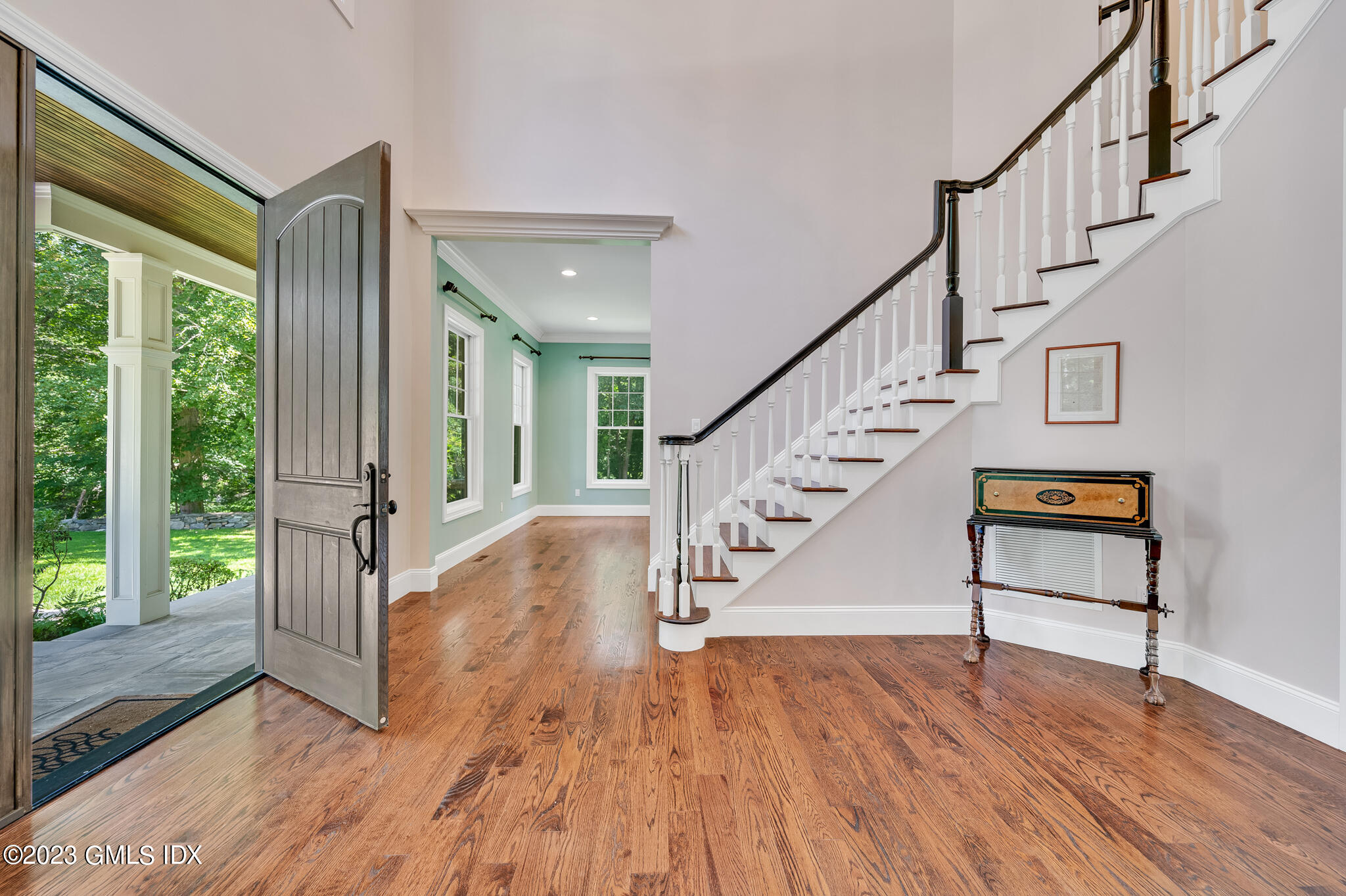 58 Perkins Road Greenwich, CT 06830 - Photo 2 of 30 a view of staircase with wooden floor and a floor to ceiling window