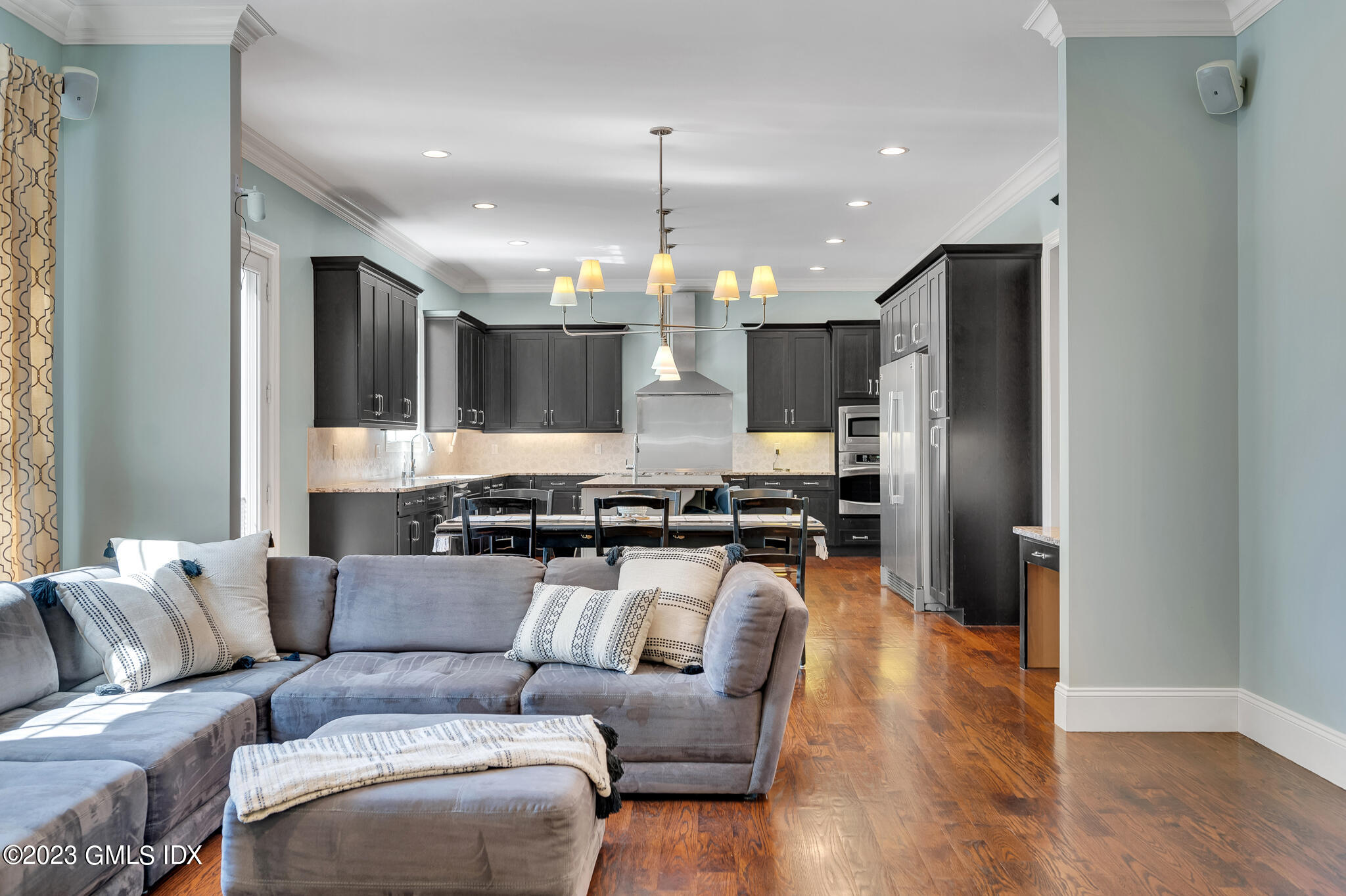 58 Perkins Road Greenwich, CT 06830 - Photo 8 of 30 a kitchen with stainless steel appliances kitchen island granite countertop a refrigerator a stove a oven and a dining table with wooden floor