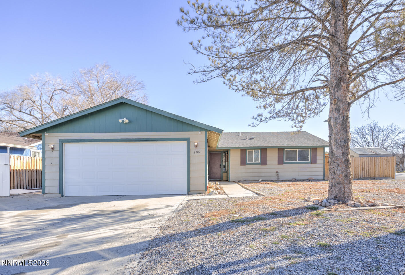 590 Fargo Way Fernley, NV 89408 - Photo 2 of 25 a front view of a house with a yard and garage
