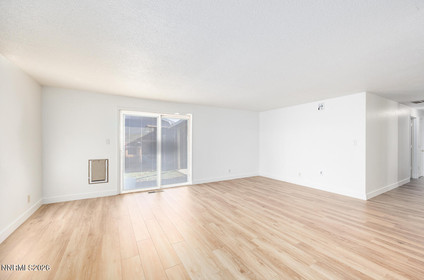 590 Fargo Way Fernley, NV 89408 - Photo 3 of 25 an empty room with wooden floor and windows