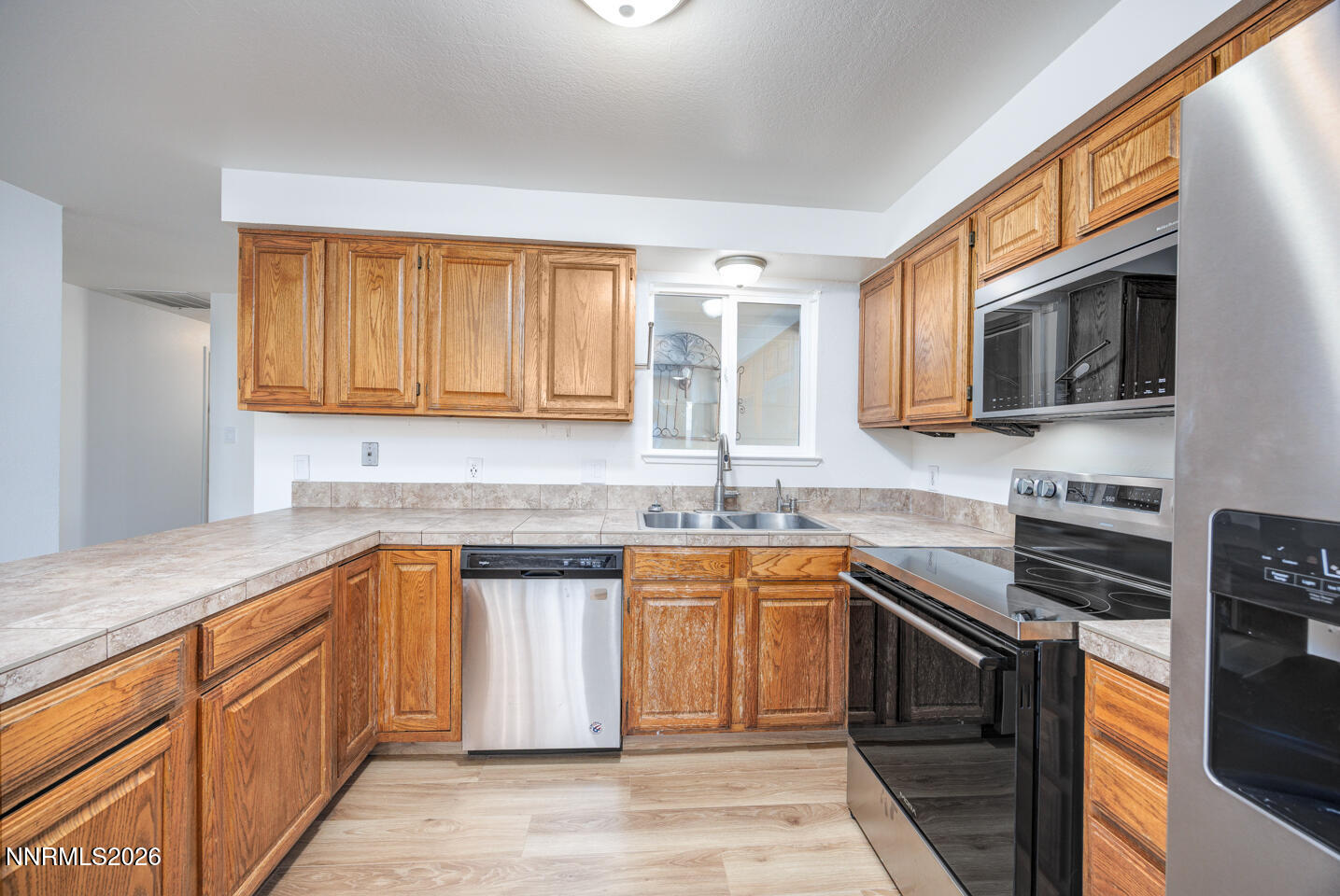 590 Fargo Way Fernley, NV 89408 - Photo 6 of 25 a kitchen with stainless steel appliances granite countertop a sink stove and microwave