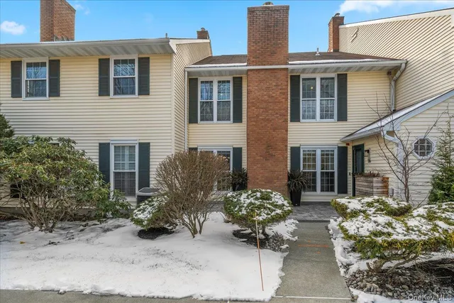 a view of a house with potted plants