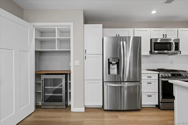 a kitchen with wooden cabinets and stainless steel appliances