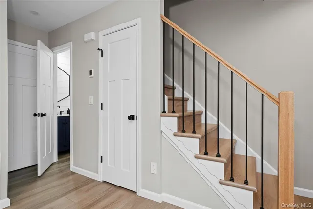 a view of an entryway with wooden floor and door