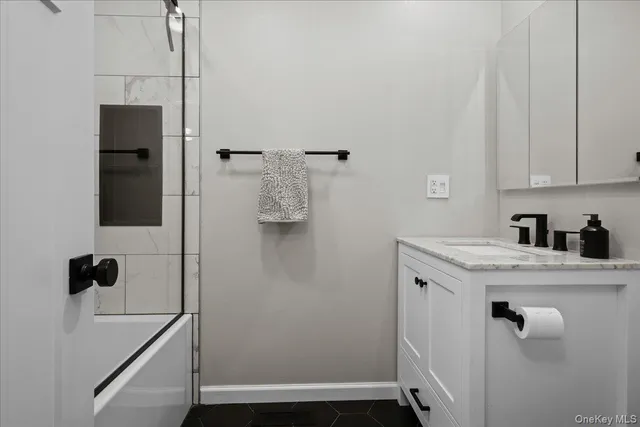 a bathroom with a granite countertop sink
