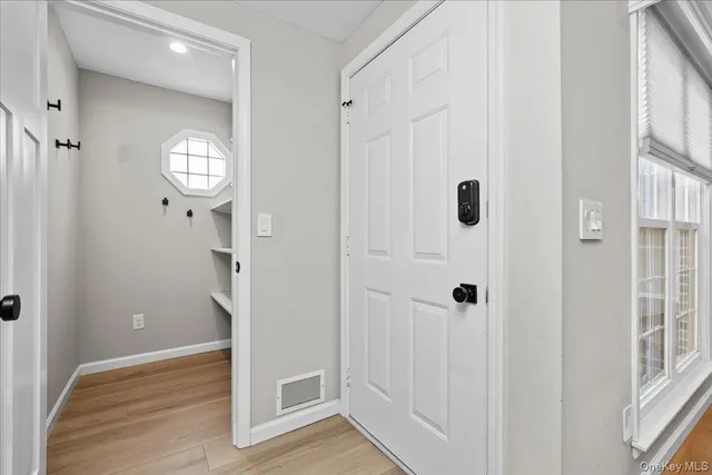 a view of a hallway with wooden floor