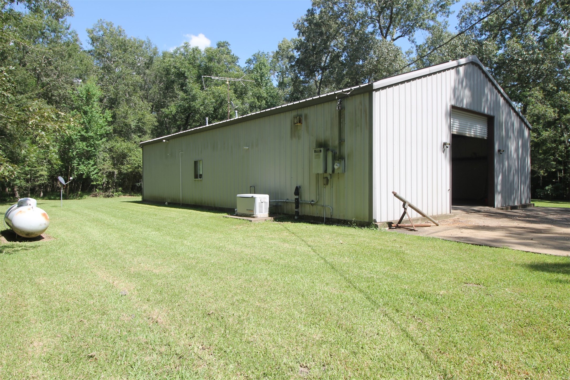 1528 County Road 2005 Liberty, TX 77575 - Photo 8 of 26 a backyard of a house with table and chairs and a large tree