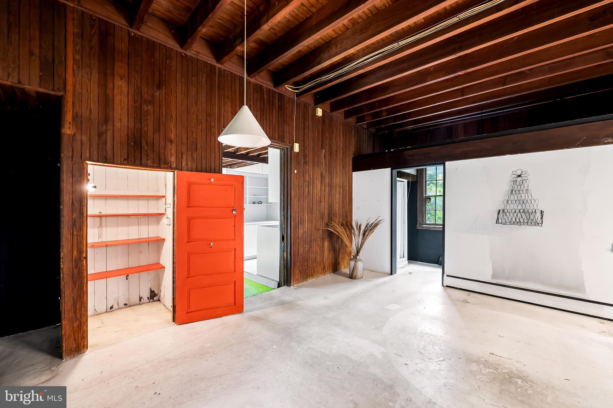 7901 Ruxwood Road Baltimore, MD 21204 - Photo 25 of 85 a view of an empty room with wooden floor and windows