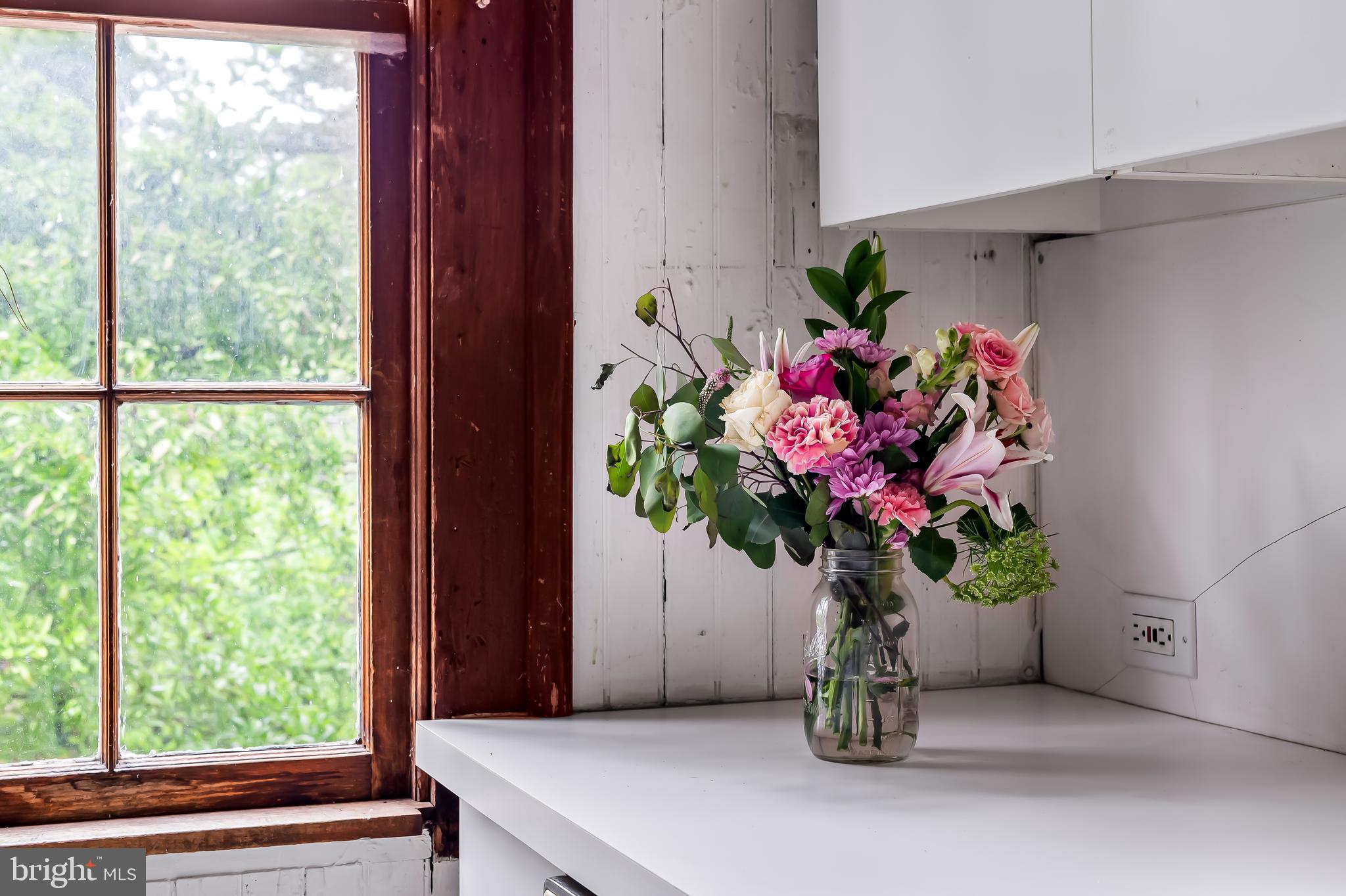 7901 Ruxwood Road Baltimore, MD 21204 - Photo 54 of 85 a vase of flowers sitting on a floor next to a window