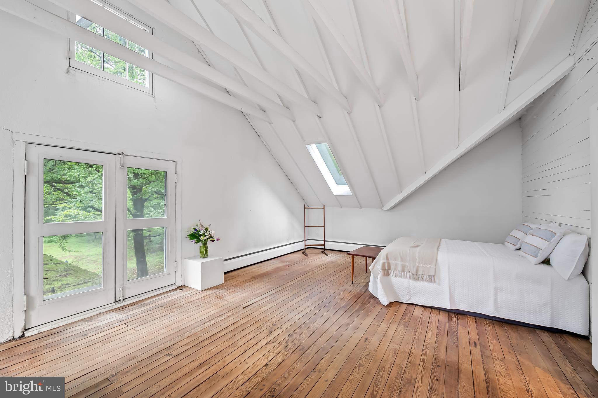 7901 Ruxwood Road Baltimore, MD 21204 - Photo 65 of 85 a view of an empty room with wooden floor and a window