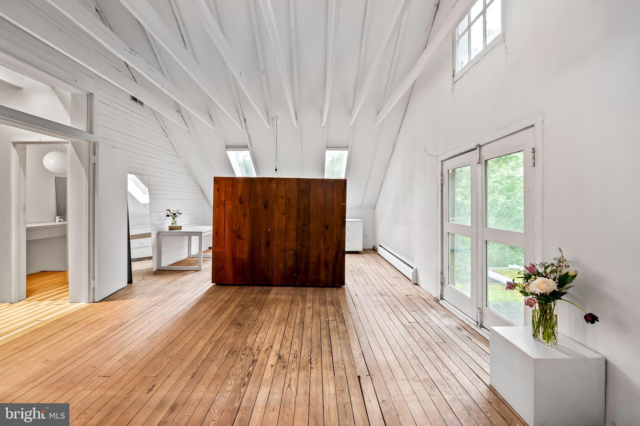 7901 Ruxwood Road Baltimore, MD 21204 - Photo 69 of 85 a view of a room with wooden floor and a balcony