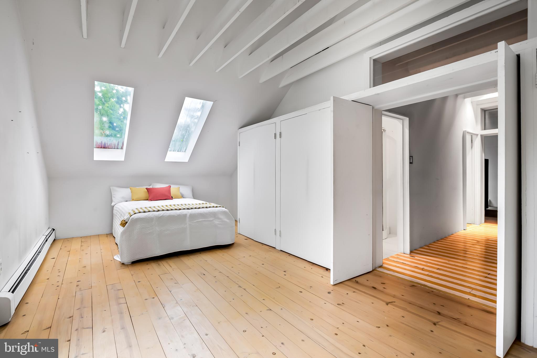 7901 Ruxwood Road Baltimore, MD 21204 - Photo 76 of 85 a bedroom with a bed and wooden floor