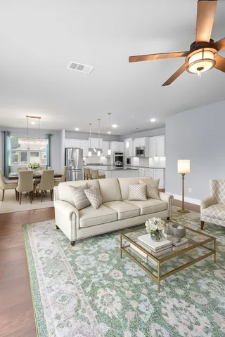a view of kitchen and hall with wooden floor