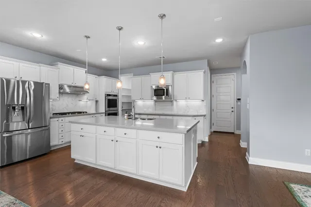 a living room with furniture a lamp and a rug