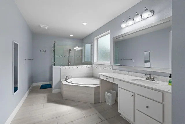 a spacious bathroom with a toilet sink and mirror