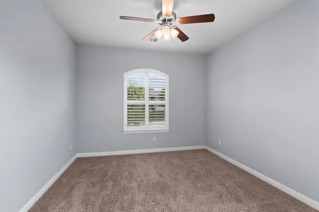 a room with pool table and windows