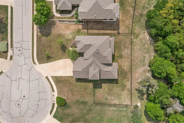 an aerial view of a house with a yard