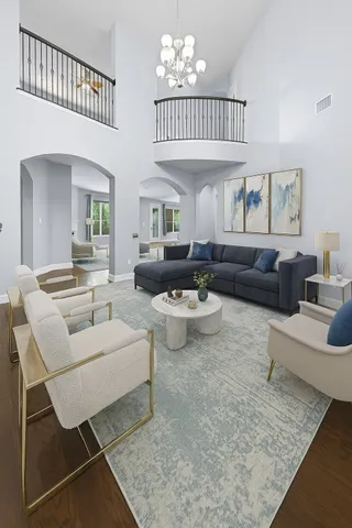 a living room with furniture a couch and a chandelier