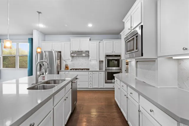 a kitchen with stainless steel appliances granite countertop a sink and cabinets