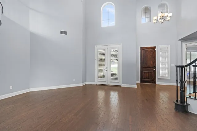 a view of a hallway with entryway and wooden floor