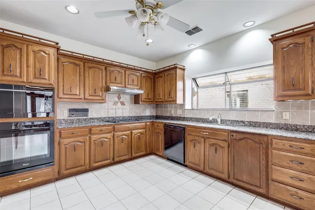 a kitchen with stainless steel appliances granite countertop a sink and cabinets