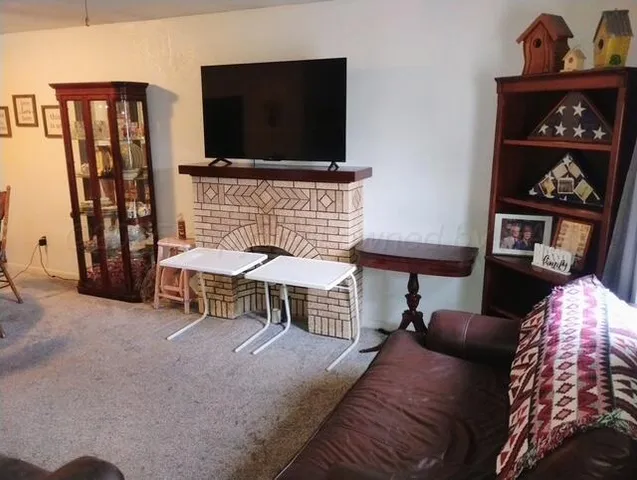 a bedroom with furniture and a flat screen tv