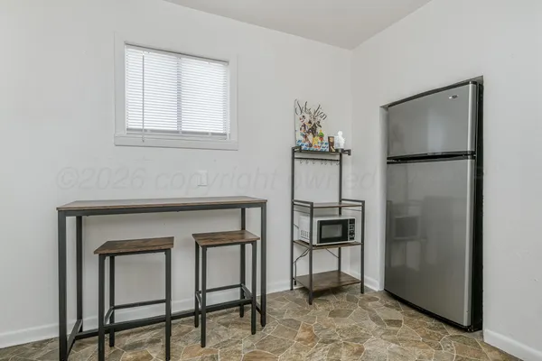 an empty room with chandelier fan
