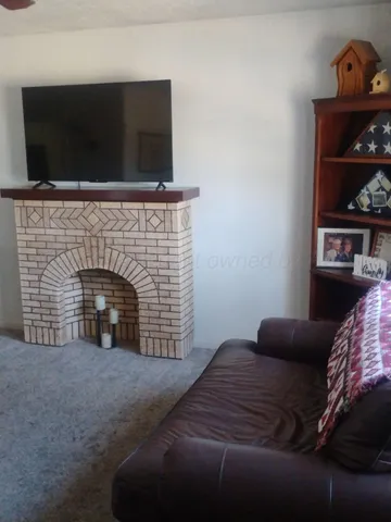 a bedroom with a fireplace and television