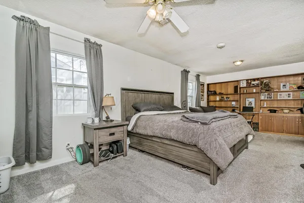 a bedroom with a bed couch and window