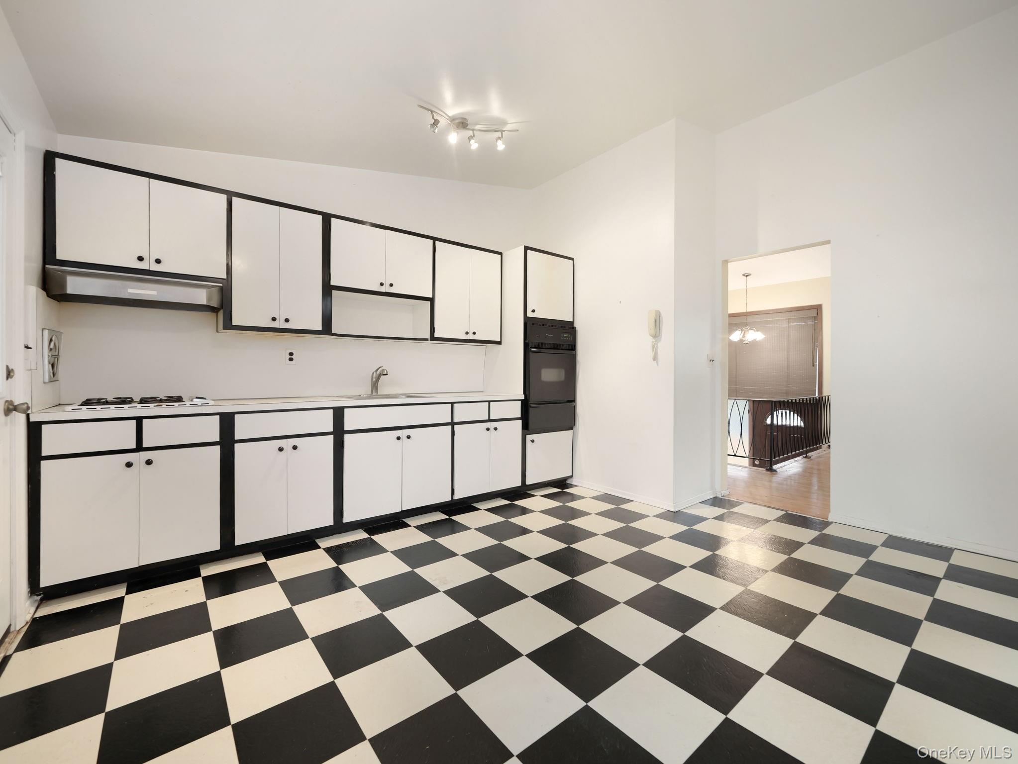 6 Pennington Way Spring Valley, NY 10977 - Photo 12 of 34 Kitchen with lofted ceiling, light countertops, white cabinetry